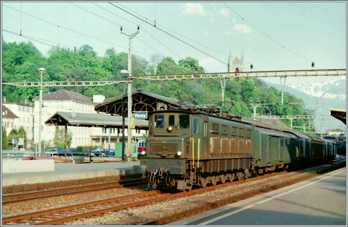Im Spätsommer 1995 fährt eine Ae 4/7 mit einem Postzug auf dem nun seit längerem verschwunden Gleis 2 in Vevey durch. Neben der Ae 4/7 ist im Hintergrund noch eine CEV Altbautriebwagen zu erkennen, wahrschienlich der BDe 2/4 103.
