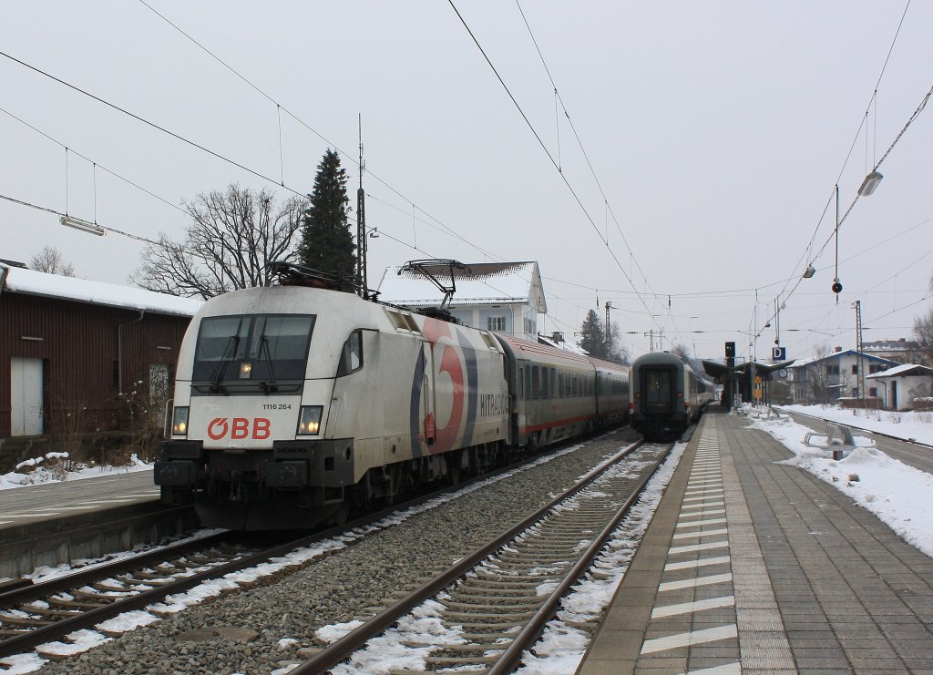 1116 264  3 Hitradio -Taurus mit einem Korridorzug im Bahnhof von Prien am Chiemsee. Aufgenommen am 25. Februar 2013.