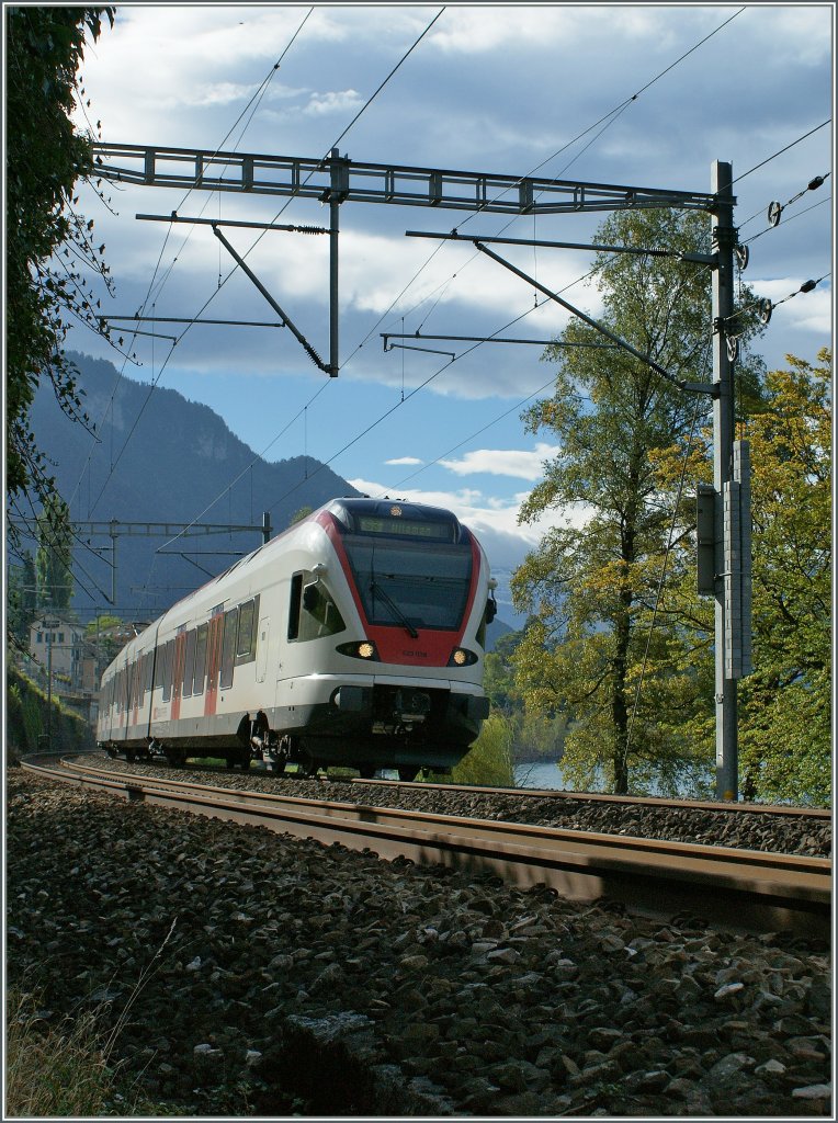 Im Gegenlicht: Ein SBB Flirt RABe 523 beim Château de Chillon am 4. Okt 2010.