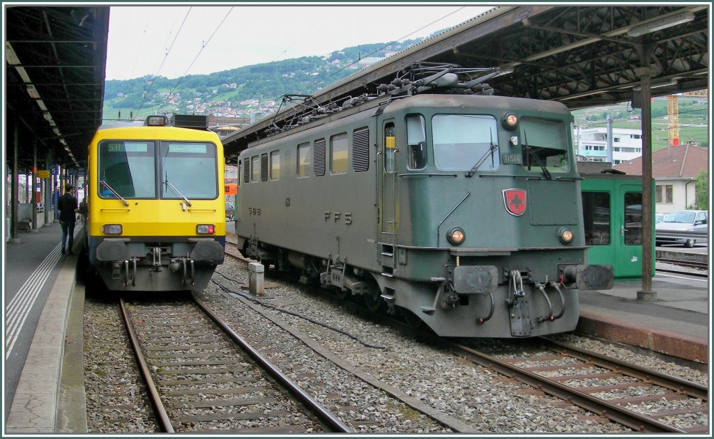 In Vevey, neben dem Bt des Train des Vignes wartet die Ae 6/6 11514 auf die Ausfahrt Richutng Montreux. 
18. juni 2010