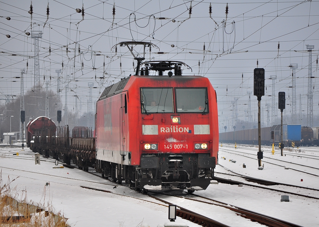 Mit dem Schadwagenzug nach Eberswalde verlsst die 145 007 am 14.12.2012 den Bahnhof Rostock-Seehafen. 