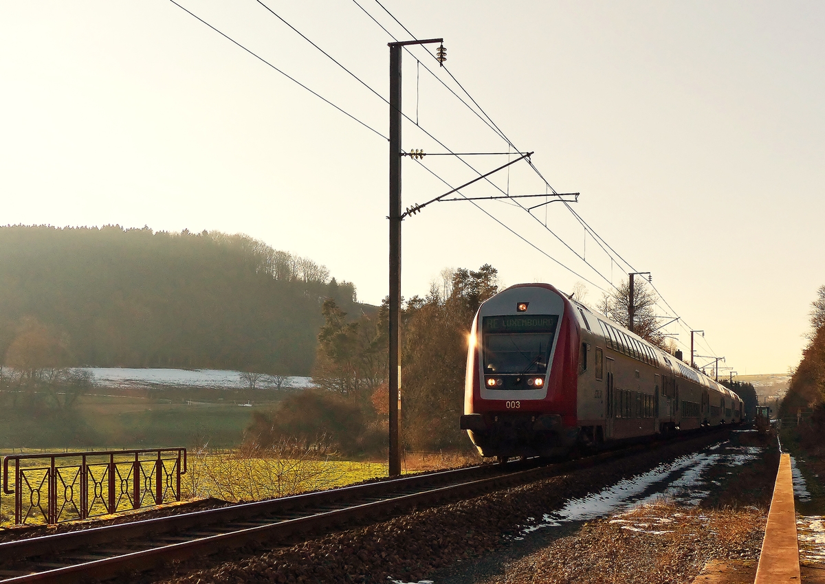 . Der Schnee ist (fast) weg, jetzt muss es die Abendsonne richten - Steuerwagen voraus fhrt der RE 3841 Troisvierges - Luxembourg im abendlichen Gegenlicht des 11.02.2015 ber den eingleisigen Abschnitt der Nordstrecke zwischen Cinqfontaines und Maulusmhle. Schublok war die 4018. (Jeanny) 