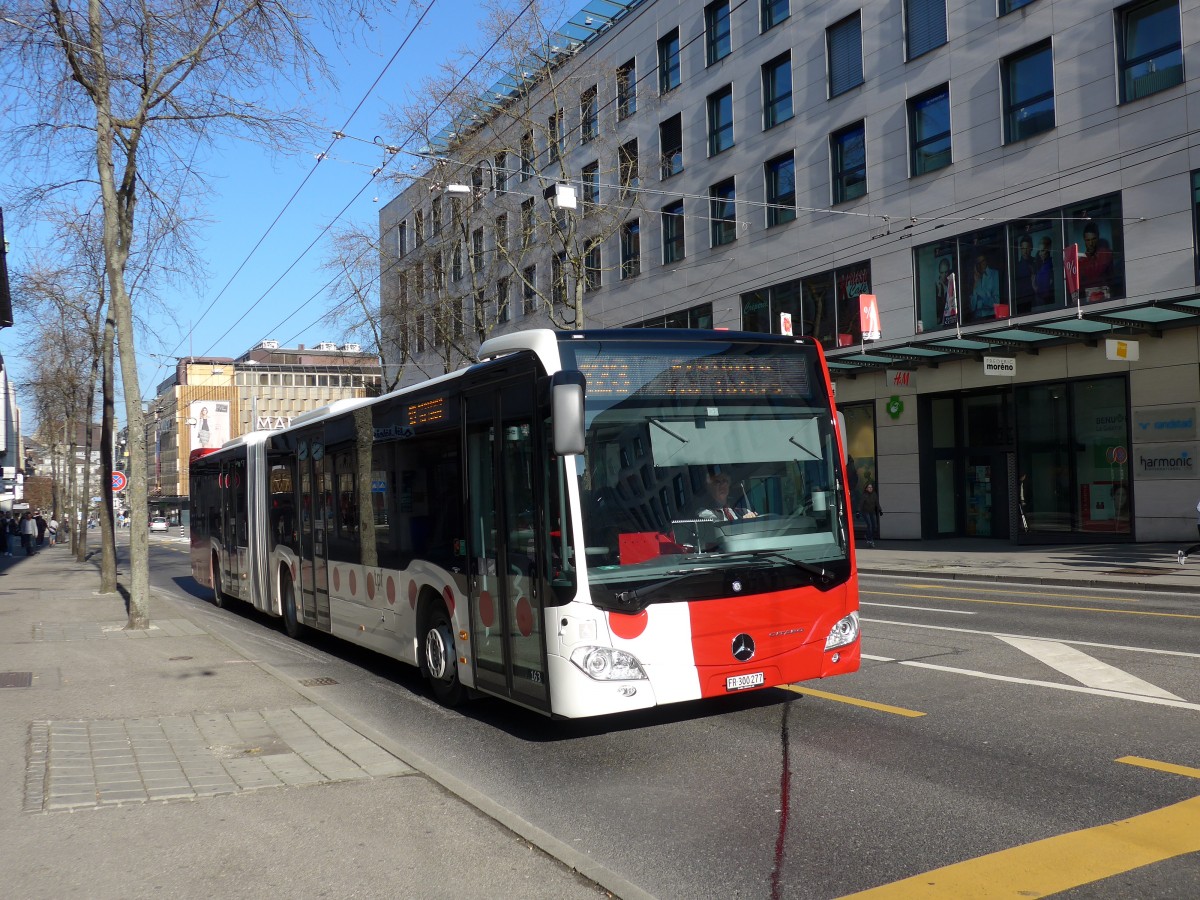 (149'281) - TPF Fribourg - Nr. 163/FR 300'277 - Mercedes am 9. Mrz 2014 beim Bahnhof Fribourg