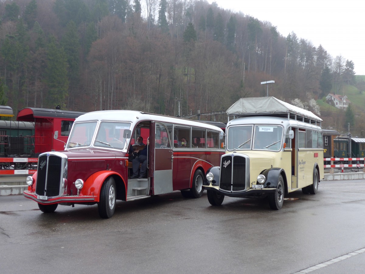 (149'585) - Biegger, Uster - Nr. 2/GL 1393 - Saurer/Lauber (ex Tlverbier, Verbier Nr. 2; ex Werkbus; ex Rey, Ayent) + Nr. 32/GL 1948 - Saurer/R&J (ex Redbull (Schweiz), Baar; ex Brandt, D-Reichersbeuern; ex Bach, NL-Amsterdam; ex Hgli, Steinach; ex EHC Biel; ex Leuenberger, Thun; ex AvH Heimenschwand) am 6. April 2014 beim Bahnhof Bauma