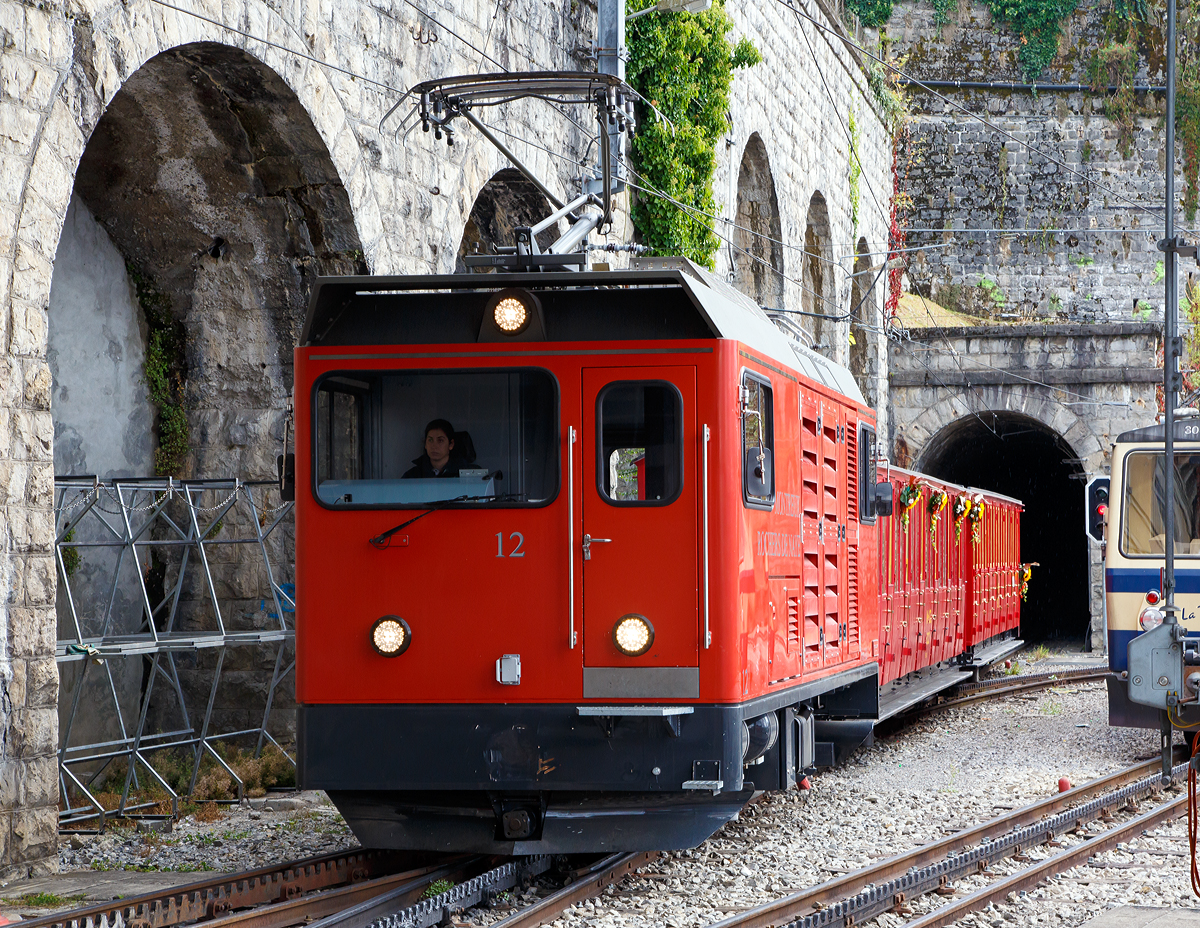 
Auf unserer kleinen Reise durch die Schweiz und Norditalien, reichte es auf der Rückfahrt noch für einen Stopp in Montreux. Eigentlich weniger für dieses Bahnbild, sondern mehr um einen lieben Freund zu treffen.....
Anlässlich der 125 Jahre Glion Rochers de Naye, die moderne Hem 2/2 N° 12 am 16.09.2017 mit den  Belle Epoque Zug  gerade wieder in Montreux an.

Die Transports Montreux-Vevey-Riviera bestellte 2012 bei Stadler Bussnang zwei dieser speziellen  elektrischen Zahnradlokmotiven mit Hilfsdieselmotor (Zweikraft-Zahnradlokomotive). Diese Fahrzeuge werden für Bauzüge und, zusammen mit einer Schneeschleuder, für die  Schneeräumung  eingesetzt.  Im Sommer bei schönem Wetter befördern sie zudem die offenen Belle-Epoque-Wagen auf den Rochers-de-Naye hoch über dem Lavaux. Passend dazu wurde auf die Gestaltung der Lok mit einem schlichten, einfachen Design besondere Rücksicht genommen.
Durch die feuchte Luft vom Lac Léman bildet sich im Winter an der Fahrleitung partiell Eis. Um diese Abschnitte trotzdem befahren zu können, wurde eine moderne Hilfsdieselgruppe eingebaut. Für die Beförderung von schweren Bauzügen und für Sondertransporte können beide Lokomotiven in Vielfachsteuerung eingesetzt werden. Zur Erhöhung der betrieblichen Flexibilität ist eine Funkfernsteuerung vorhanden.

Technische Merkmale :
Drehstrom-Asynchron-Antriebstechnik mit ABB-Stromrichter - stufenlos regulierbar mitsehr guten Langsamfahreigenschaften
Hilfsdieselmotor Deutz für das Befahren von Streckenabschnitten mit schlechtem Fahrleitungskontakt
Rekuperation der Bremsenergie, Widerstände für die Nottalfahrt bei Ausfall der Fahrleitung
Beidseitig massiver Schneeräumer
Platz für bis zu 10 Personen in der Lok (Bauzüge, Evakuationen)
Ungebremste Last: es können bis zu 3 t bei gleichbleibender und 8 t bei reduzierter Geschwindigkeit mitgeführt werden
Direkte 850VDC-Leitung zur Schneefräse

TECHNISCHE DATEN:
Typ: Hem 2/2 Nr. 11 & 12
Fahrleitungsspannung: 850 VDC
Spurweite: 800 mm
Lieferjahr: 2013
Achsabstand: 3:750 mm
Raddurchmesser neu / alt: 647 / 634 mm
Triebzahnraddurchmesser: 573 mm
Länge über Kasten / Kupplung: 7.050 mm / 8.295 mm
Breite über Kasten: 2.500 mm
Höhe: 3.630 mm
Dienstgewicht: 17.350 kg
max. Leistung am Rad:  600 kW
max. Leistung im Bremsbetrieb:  600 kW
max. Leistung im Dieselbetrieb: ca. 200 kW
Max. Anfahrzugkraft am Rad: 100 kN
Vorstelllast: 18 t
Vorstelllast  ungebremst: max. 3 t bei 15/21 km/h bzw. 8 t bei 8/15 km/h
Max. Geschwindigkeit: 25 km/h
Max. Geschwindigkeit bei 130 ‰ : 21 km/h (talwärts)
Max. Geschwindigkeit bei 220 ‰ : 15 km/h (talwärts)
Hilfsbetriebe: Batterieladung 24VDC, 8kW
