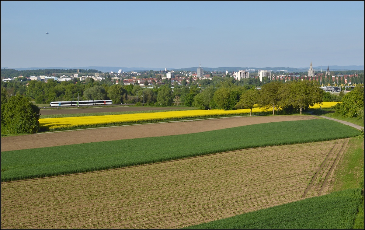 Bahn im Tägermoos. 

S14 Weinfelden-Konstanz mit GTW 2/8 im Anflug auf Kreuzlingen. Im Hintergrund die  Skyline  von Konstanz. Mai 2014.