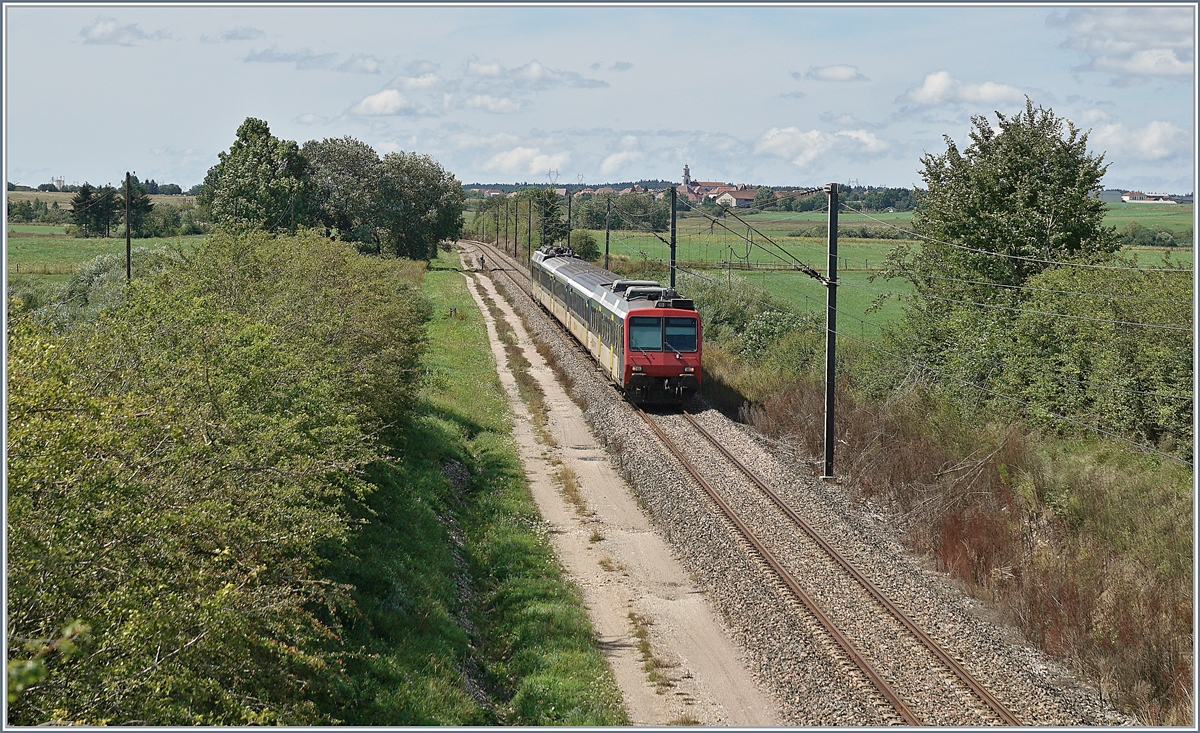 
Der hier als RE 18124 von Neuchâtel nach Frasne fahrende SBB NPZ RBDe 562 mit EW I AB, EW I B , EW I B und NPZ Bt nutzt unter der mit 25000 Volt und 50 Hz gespeisten Fahrleitung sein Mehrstromsystem. Bis Pontarlier wurde der Zug mit 15000 Volt und 16 2/3 Hertz gespeist, auch auf dem mit SNCF Fahrleitung versehen Abschnitt von der Grenze bei Les Verrières bis nach Pontarlier. Das Bild zeigt den Zug kurz nach La Rivière-Drugeon auf einem Hochplateau im französischen Jura (ca. 800 müM) und damit schon bald am Ziel seiner Reise.

21. August 2019