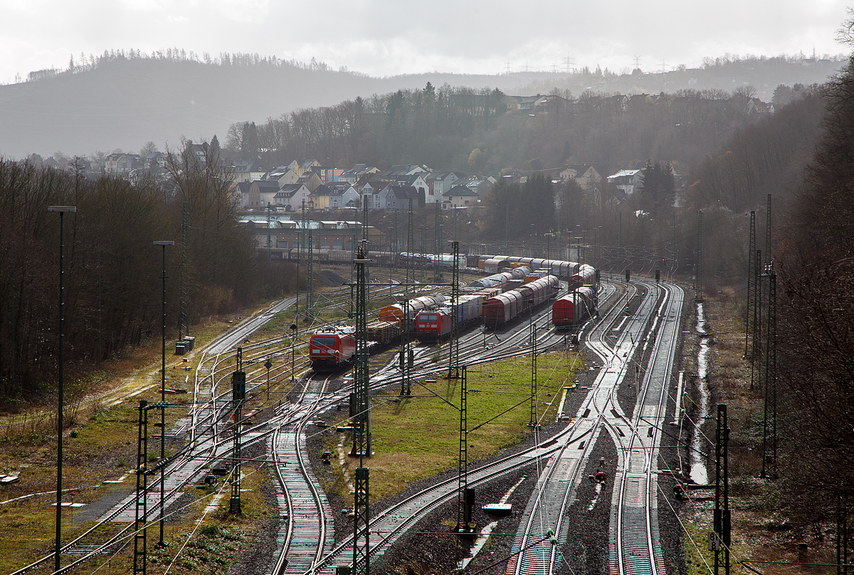 Der Orkan „Ylenia“ tobte in der Nacht vom 16. auf 17.02.2022 im Land, der Bahnverkehr ist beeinträchtigt, so war auf die Siegstrecke KBS 460 bei Niederhövels ein Baum auf die Gleise gestürzt.

Blick auf den Rangierbahnhof (Rbf) Betzdorf/Sieg (von der Brücke in Betzdorf-Bruche) am 17.02.2022, auch hier sieht man auch die Auswirkung von „Ylenia“. Zwei von TRAXX F140 AC1 der DB Cargo bespannte Güterzüge sind abgestellt. Es waren links die 185 074-2 und rechts die Frankreich taugliche 185 033-8. Wobei die beiden Lokführer der DB Cargo wohl Feierabend machen konnten, da die Züge im Rbf abgestellt waren. Nicht wie bei dem Lokführer der RTB CARGO über 7 Stunden in Scheuerfeld (Sieg) warten musste. Da wird es wohl mit der maximalen Schichtzeit nicht hin hauen.