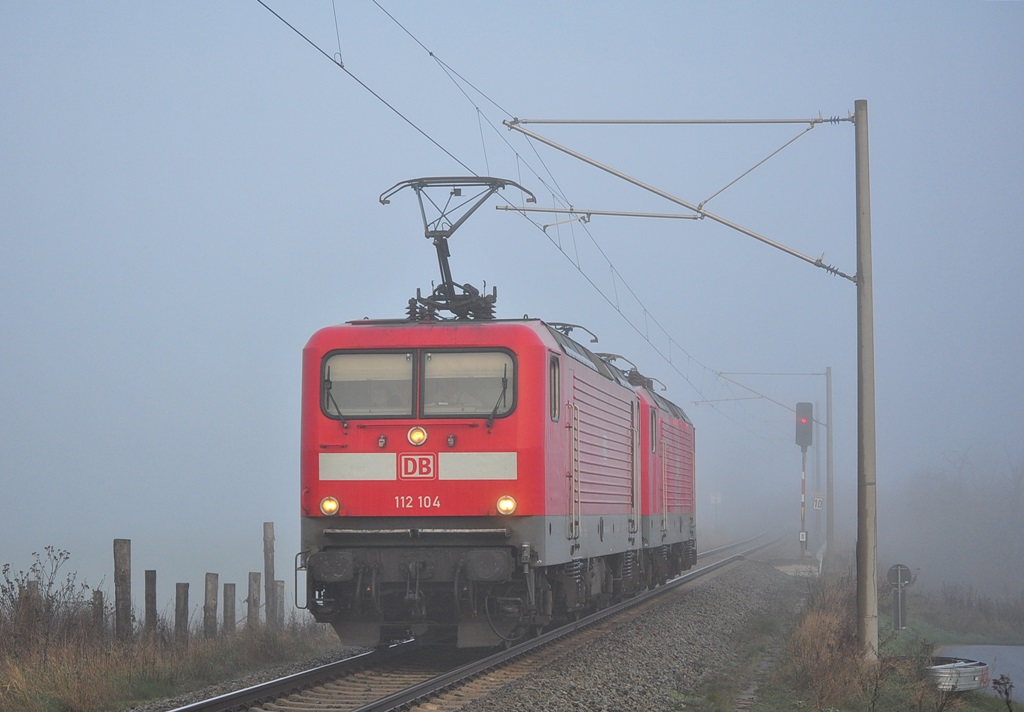 Die 112 104 und die 114 005 sausen am 25.11.2014 durch das völlig vernebelte Gragetopshof in Richtung Kavelstorf.