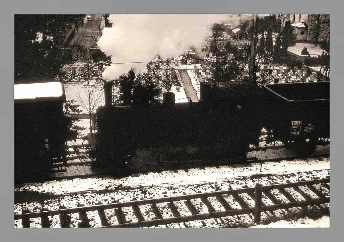 Die Gaswerkbahn Bern: Ich besass im Dezember 1964 nur eine kleine Kamera ohne Einstellungsmglichkeiten. Das ergab in diesen trben schneereichen Tagen leider keine guten Bilder. Dennoch seien einige Aufnahmen hochgeladen, die etwas von der damaligen Atmosphre eines ganz normalen Dampfbetriebs mit allerlei Strecken- ebenso wie Rangieraufgaben wiederspiegeln. Hier rangiert die Gaswerk-Dampflok Gterwagen fr die Grbetalbahn (GBS, heute BLS); im Hintergrund der alte Friedhof von Wabern.  