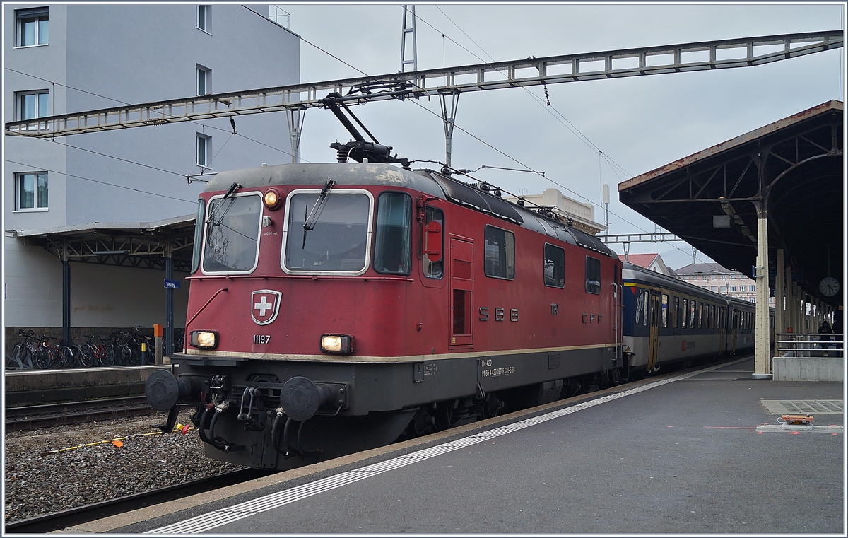 Die Re 4/4 II 11197 wartet in Vevey mit ihrem Dispozug (und der Re 4/4 II 11194 am Zugschluss) als IR90 1725 auf die Ausfahrt.

30. Januar 2020