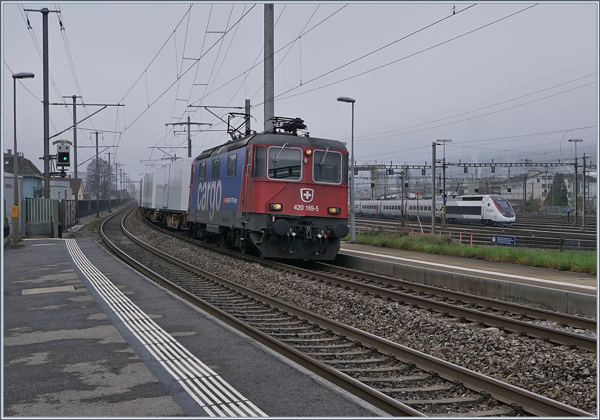 Die SBB Cargo Re 420 169-5 bei der Durchfahrt in Biel Mett, im Hintergrund, im Rangierbahnhof wartet der TGV 4415 auf die Abfahrt nach Bern.

5. April 2019
 
