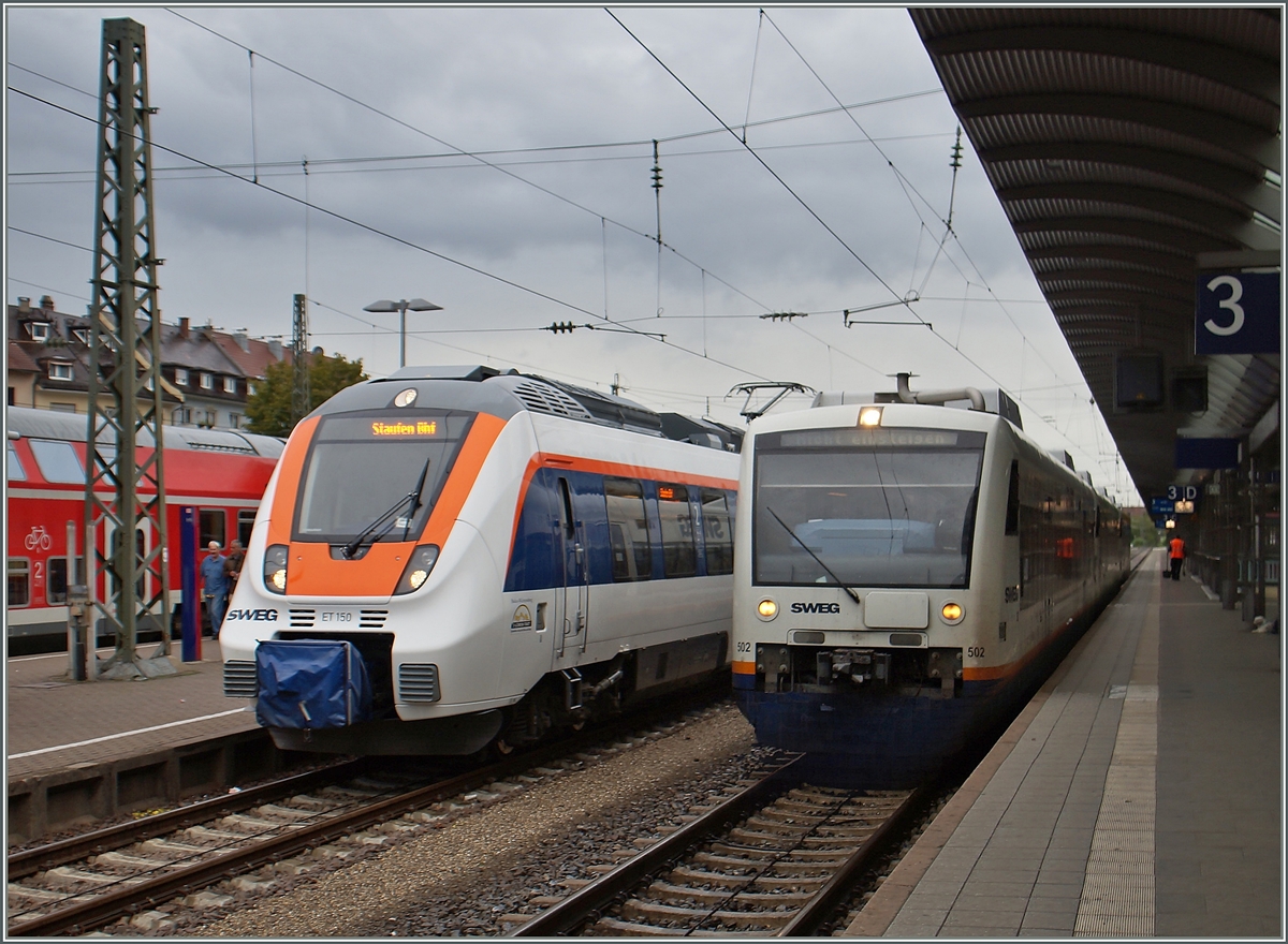 Ein bunter Hamster (UIC 9480 1442 650-6 D-SWEG) neben dem schlichten VT 650 in Freiburg im Breisgau .
17. Sept. 2015