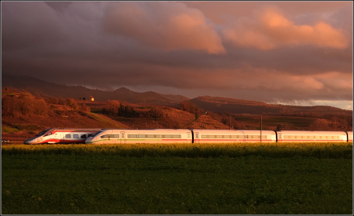 Einer der wenigen Trenitalia-ETR 610 taucht unerwartet hinter dem ICE 4-Triebzug 9041 auf. Hügelheim, November 2021.