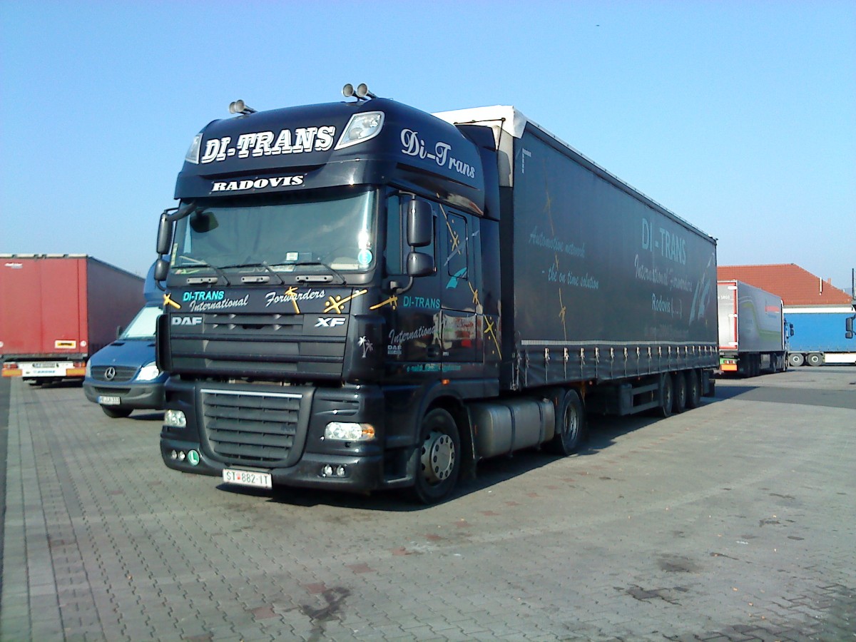 SZM DAF XF mit Pritsche-Planen-Auflieger der Spedition DI-trans gesehen auf dem Autohof in Grnstadt am 10.03.2014