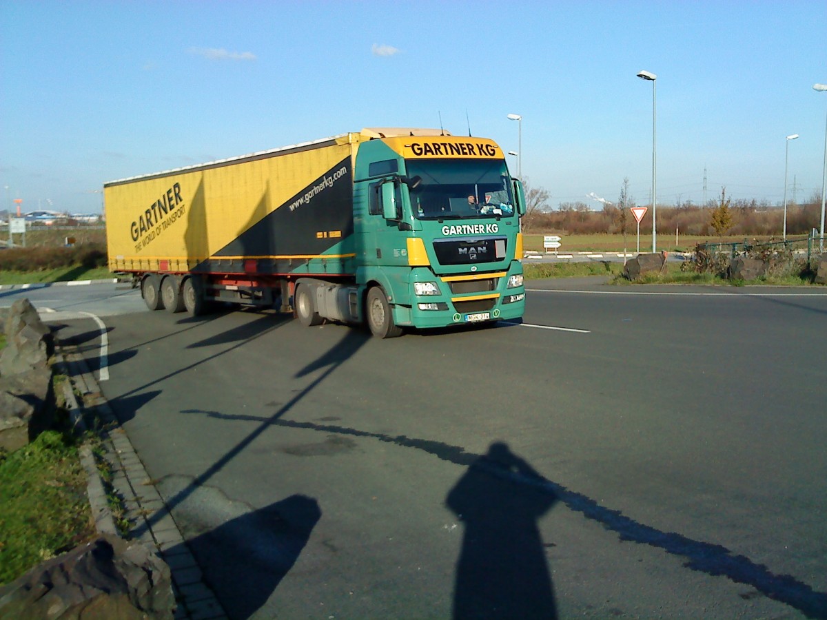 SZM MAN TGA mit Pritsche-Planen-Auflieger der Spedition Grtner KG auf dem Weg zum Autohof in Grnstadt am 02.12.2013