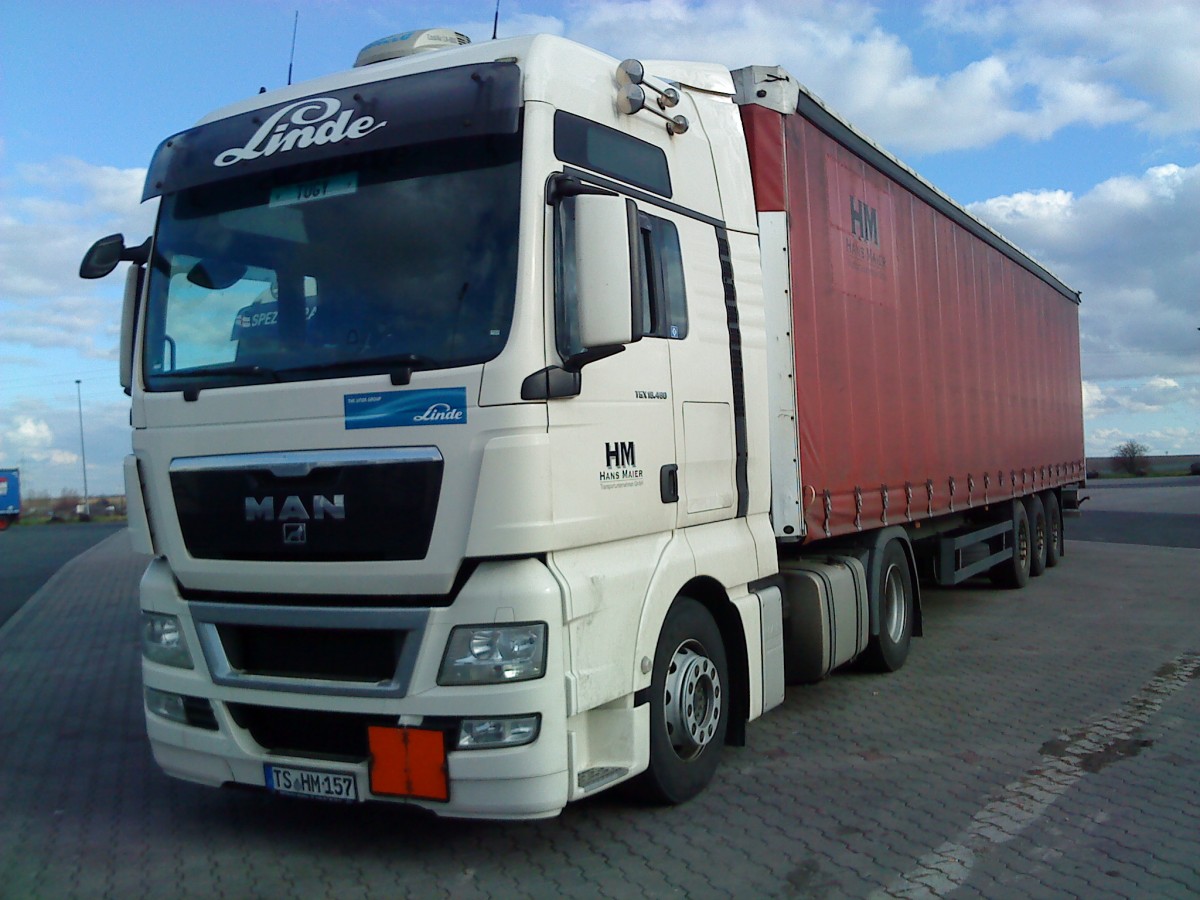 SZM MAN TGX 18.440 mit Pritsche-Planen-Auflieger der Spedition Hans Maier gesehen auf dem Autohof in Grnstadt am 18.02.2014