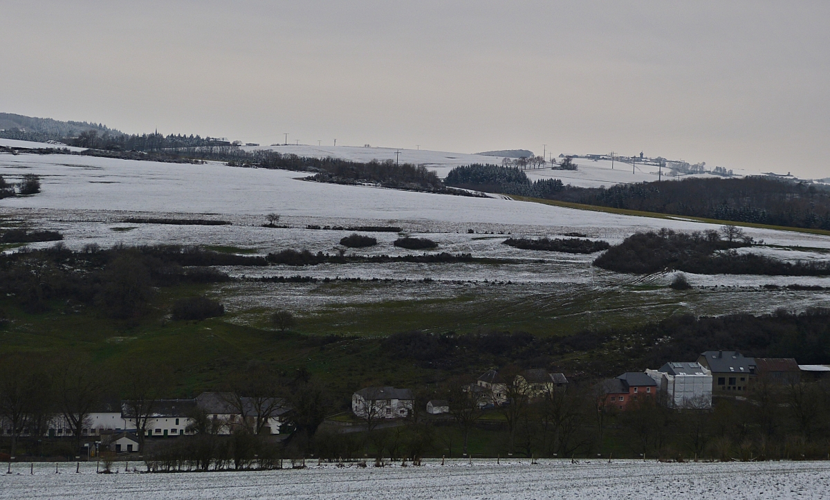 Weiße Winterlandschaft und grüne Wiesen,  bei einer Höhe von ca. 300 m über dem Meeresspiegel ist die Schneefallgrenze in der Nähe von Wiltz gut zu sehen. 03.01.2021 