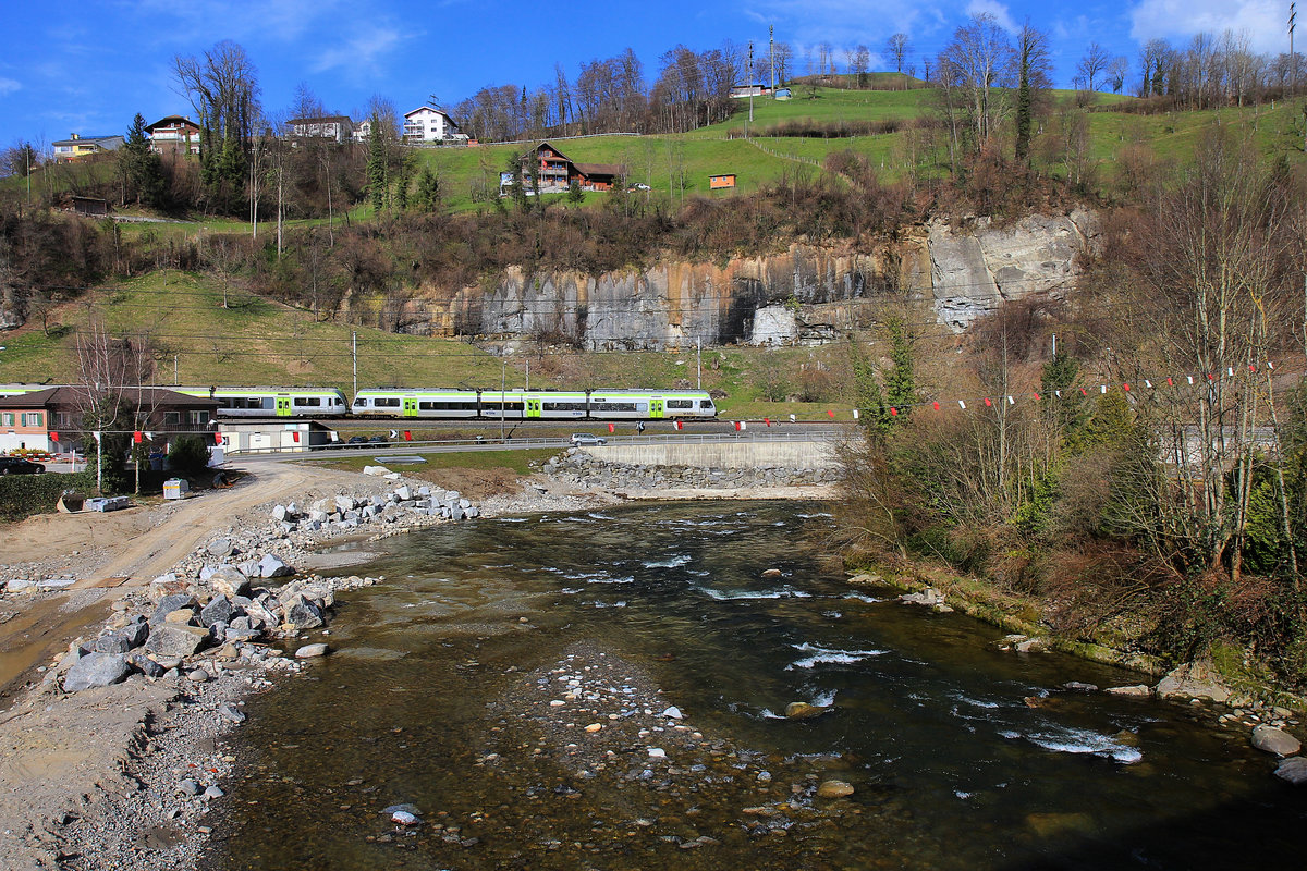 Werthenstein: Von der uralten gedeckten Holzbrücke über die Kleine Emme aus gesehen ein S-Bahnzug mit BLS NINA (Nr. 007) und BLS Lötschberger. 