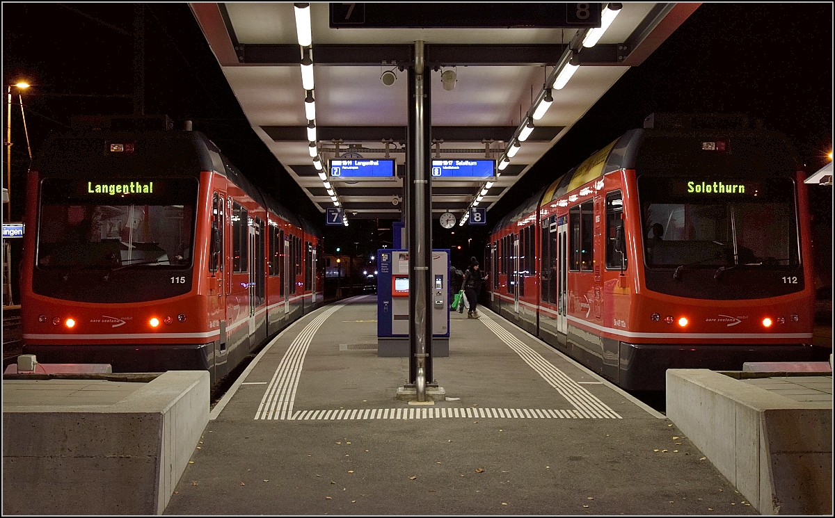 Zum Vergleich zu Horsts Bild vom Kopfbahnhof Niederbipp. http://igschieneschweiz.startbilder.de/bild/schweiz~strecken~413-solothurn-8211-niederbipp-8211-langenthal/538646/die-snb-be-44-301-und-302.html 

Der neue Kopfbahnhof im nächsten Ort und neuer Name der Bahn. Aare Seeland mobil wartet in Oensingen auf den Anschluss der Gäubahn. Beide Bahnen fahren hintereinander erst nach Niederbipp und dann trennen sich die Wege Richtung Solothurn und Langenthal. ABe 4/8 115 und 112 stehen hier zur Abfahrt bereit. Oensingen, Dezember 2016.
