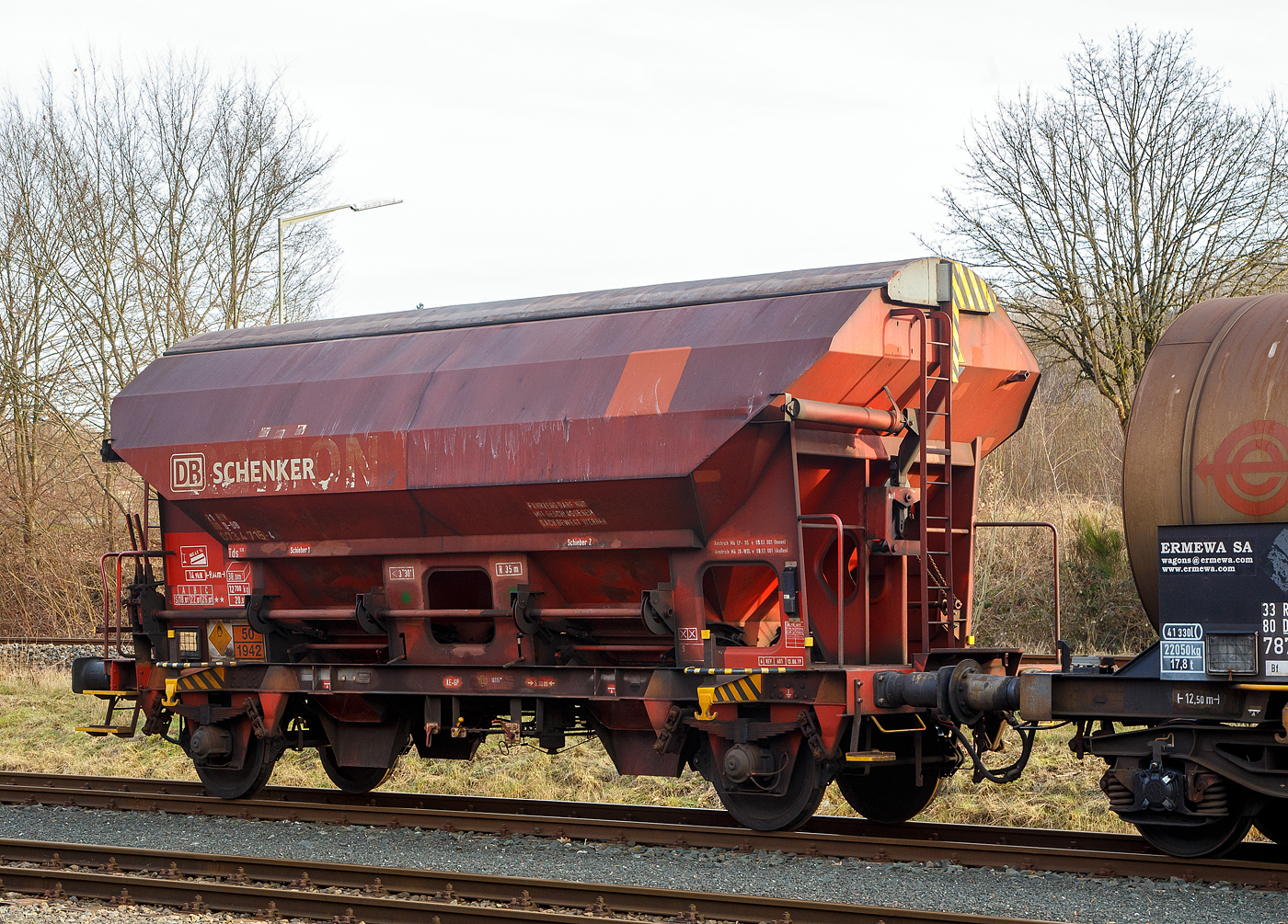 2-achsiger Gedeckter Schttgutwagen mit dosierbarer Schwerkraftentladung 21 80 0734 715-4 D-DB, der Gattung Tds 938, der DB Cargo AG, abgestellt am 09.02.2023 in Herdorf, im Zugverband auf dem Rbf der KSW.

In diesen Wagen wird Ammoniumnitrat (Gefahrgutnummer 50/1942) zur Sprengstoff Herstellung zur Fa. Dynamit Nobel Defence nach Burbach-Wrgendorf gefahren (hier ist er leer).  Ammoniumnitrat ist der Stoff  von dem ca. 2.750 Tonnen im Hafen von Beirut am 4. August 2020 explodierten und zur der bekannten gewaltigen Explosionskatastrophe fhrten.

TECHNISCHE DATEN:
Spurweite: 1.435 mm
Achsanzahl: 2
Lnge ber Puffer: 9.640 mm
Achsabstand: 6.000 mm
Laufraddurchmesser: 1.000 mm (neu)
Wagenhhe: 4.198mm
Gre der Beladeffnung Lnge x Breite: 8.000 x 1.200 mm
Laderaum: 38 m
Eigengewicht: 12.700 kg
Hchstgeschwindigkeit: 100 km/h (beladen) / 120 km/h (leer)
Maximales Ladegewicht: 26,0 t  ab Streckenklasse C
Kleinster bef. Gleisbogenradius: 35 m
Bauart der Bremse: KE-GP (LL)
Bremssohle: IP 116
Intern. Verwendungsfhigkeit: RIV