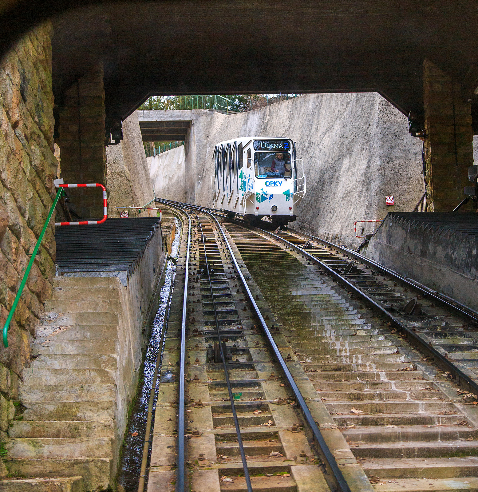 Begegnung in der abtschen Ausweiche an der Mittelstation Jelení skok (Hirschsprung) der Standseilbahn Diana (tschechisch Lanová dráha Diana) in Karlsbad (Karlovy Vary) am 18.04.2023, der Wagen „DIANA 2“ kommt hinab.