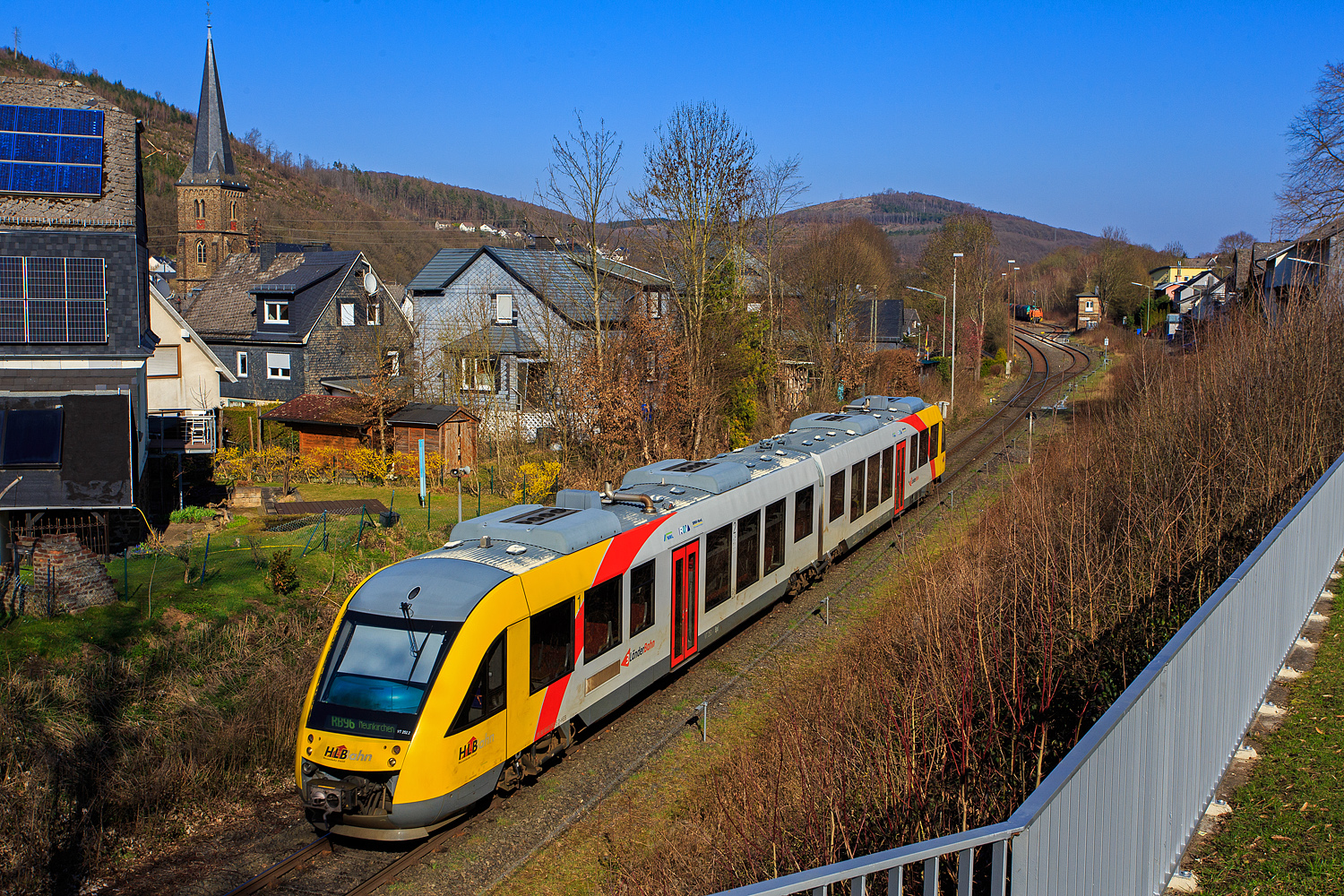 Der VT 252 (95 80 0648 152-6 D-HEB / 95 80 0648 652-5 D-HEB), ein Alstom Coradia LINT 41 der HLB (Hessische Landesbahn), ex Vectus VT 252, erreicht als RB 96 „Hellertalbahn“ von Betzdorf/Sieg nach Neunkirchen (Kr Siegen), am 19 März 2026 den Bahnhof Herdorf. Hinten auf Gleis 4 im Bahnhof wartet bereits die KSW 45 (98 80 0276 016-9 D-KSW), die MaK G 1204 BB der Kreisbahn Siegen-Wittgenstein, mit einem Übergabezug. 

Der Alstom Coradia LINT 41 wurde 2004 von der ALSTOM Transport Deutschland GmbH (vormals LHB - Linke-Hofmann-Busch GmbH) in Salzgitter-Watenstedt unter der Fabriknummer 1188-002 gebaut und an die vectus Verkehrsgesellschaft mbH geliefert, mit dem Fahrplanwechsel am 14.12.2014 wurden alle  Fahrzeuge der vectus nun Eigentum der HLB.