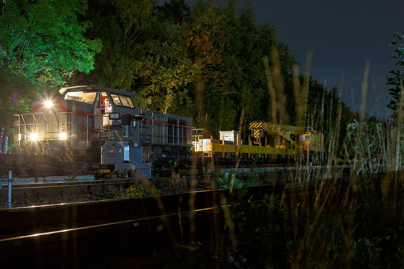 Die 271 006-9 „Julius“ (92 80 1271 006-9 D-KAF), eine Vossloh G 1000 BB, der KAF - Falkenhahn Bau AG (Kreuztal) hat am Abend des 10 Oktober 2025 auf Gleis 4, mit einem Kranzug der Hering Bahnbau, sowie mit einigen Flachwagen, den Bahnhof Herdorf erreicht. Hier sollen am Wochenende Weichen gewechselt werden.

Der Kranzug bestand aus dem 125 t KIROW Gleisbauschienenkran KIROW Multi Tasker KRC 810 T (mit Schwerlastausrstung), D-HGUI 99 80 9419 024-1, ex 97 82 53 513 19-3, der HERING Bahnbau GmbH. Vor dem Kran der Schutzwagen auslegerseitig, 37 80 3999 048-6 D-HGUI, der Gattung Res, u.a. beladen mit der Traverse, Anschlagmittel und sonstiges Zubehr). Hinter dem Kran als Schutzwagen gegenlastseitig die vierachsige (2 x 2-achsige) lange Flachwageneinheit mit abgesenktem Fuboden (ohne Radvorlegern) 27 80 4348 084-9 D-HGUI, der Gattung Laadkks (TWA 850 RV).
