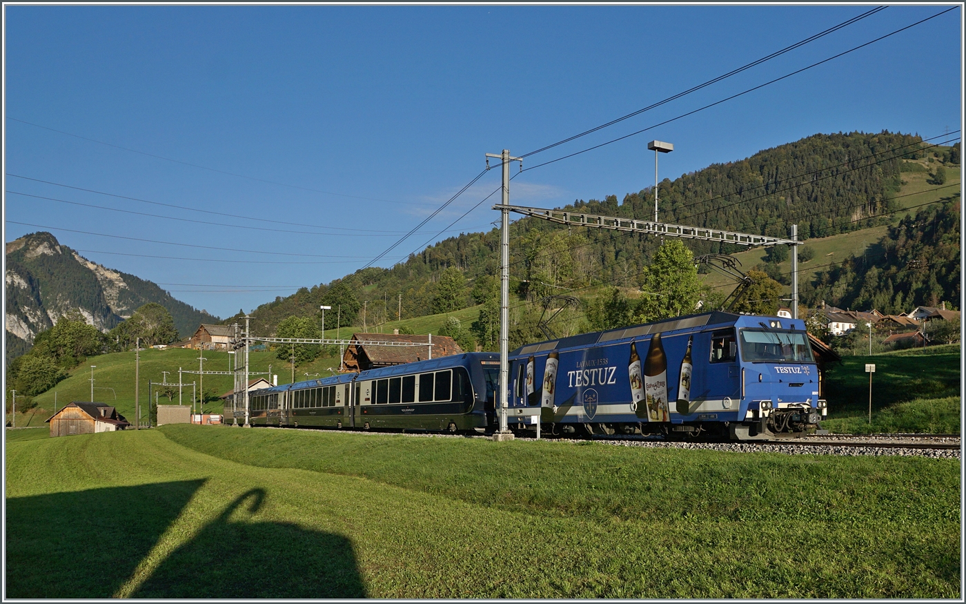 Die MOB Ge 4/4 8001 fährt mit ihrem GoldenPass Express GPX in Rossinière durch. Der Zug ist auf dem Weg von Montreux nach Interlaken Ost.

29. Sept. 2023