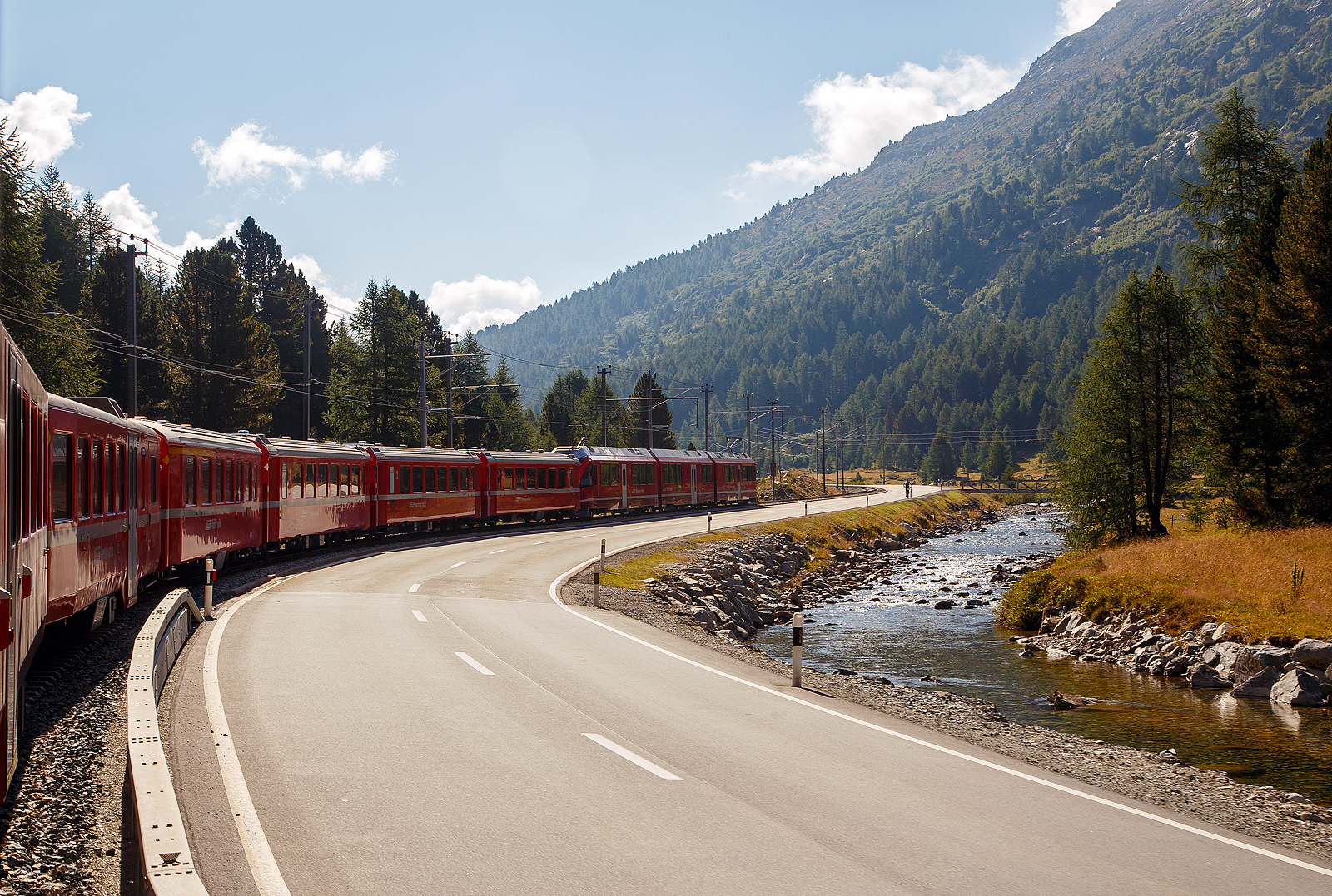 UNESCO-Weltkulturerbe Berninabahn / Ferrovia del Bernina:
Gefhrt von dem ALLEGRA-Zweispannungstriebzug ABe 8/12 RhB 3504  Dario Cologna  geht es 06.09.2021 mit dem RhB-Regionalzug nach Tirano, von der Station Morteratsch weiter hinauf nach Ospizio Bernina.Wir sind am Zugende in einem offenen Aussichtswagen.

Rechts fleit der Berninabach (Ova da Bernina).
