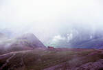 Die Lokomotiven von 1895/96 (SLM Winterthur) für die Snowdon Mountain Railway / Rheilffordd yr Wyddfa: Lok 3 nimmt den letzten Abschnitt zum Gipfel in Angriff. Durch die Wolken erkennt man rechts die riesigen Halden der Schieferminen, wo auf Terrassen kleine Bahnen den Schiefer zu den Rampen beförderten. 21.Juli 1974 