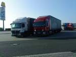 Zwei LKW SZM Mercedes-Benz Actros mit Pritsche-Plane-Auflieger der Spedition Eurosped auf dem Autohof in Grnstadt am 23.09.2013