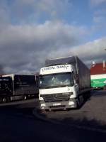 SZM Mercedes-Benz Actros mit Pritsche-Planen-Auflieger der Spedition Europa Trans gesehen auf dem Autohof in Grnstadt am 13.02.2014