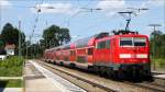 111 148 schiebt am 08.08.12 einen RE in Richtung Mnchen durch bersee