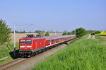 Mit dem RE 13290 voN Warnemünde nach Berlin rauscht die 112 103 durch Kavelstorf,hier am 09.05.2016.