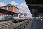 Die DB  147 578-9 wartet mit einem IC nach Stuttgart (der auch mit Nahverkehrsfahrkarten benutzt werden darf) vor dem gepflegten Bahnhofsgebäude von Singen auf die Abfahrt.