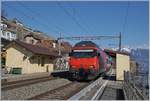 Eine SBB Re 460 mit einem IR nach Genève Aéroport in St-Saphorin.