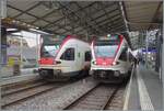 In Lausanne stehen zwei SBB Flirts RABe 523 und zeigen kleine, interessante Unterschiede: W�hrend der SBB RABe 523 026 sich in der traditionellen Farbgebung zeigt, ziert den SBB RABe 523 017 eine
