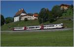 Der TPF RABe 567 182 ist bei Vaulruz auf dem Weg nach Bulle vor dem Hintergrund schmucker Gebude des Ortes.